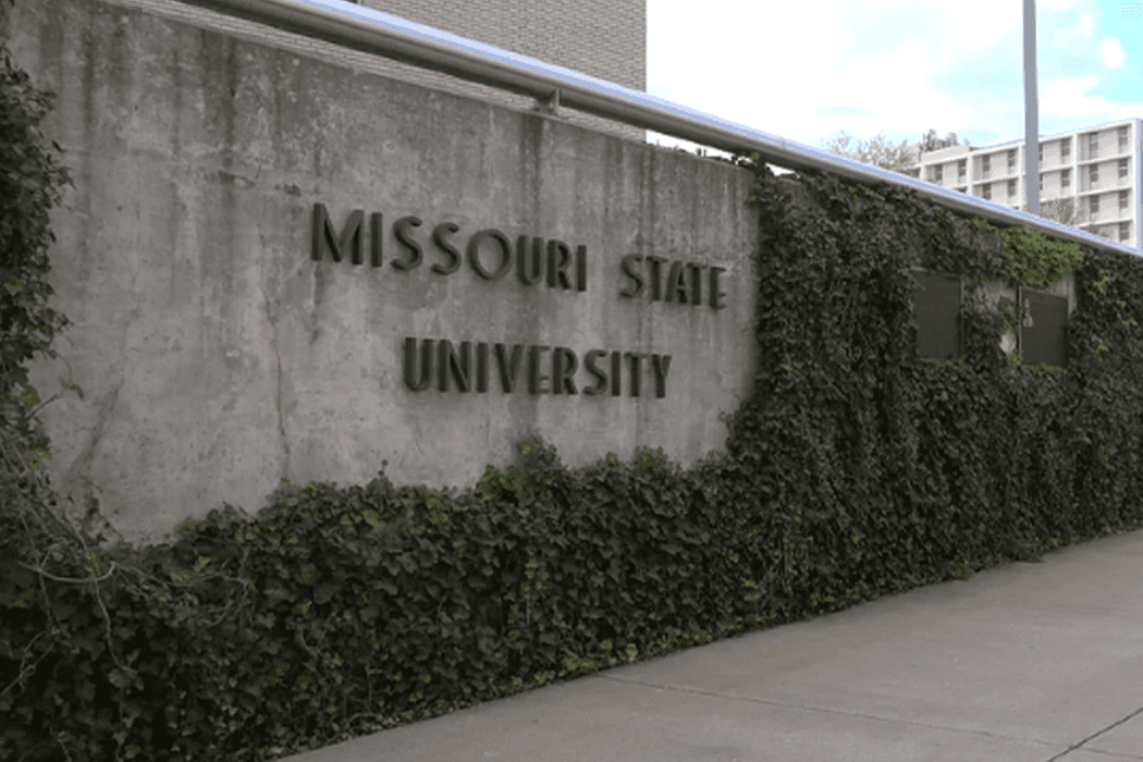 Stone wall with the words Missouri State University on it, surrounded by ivy.